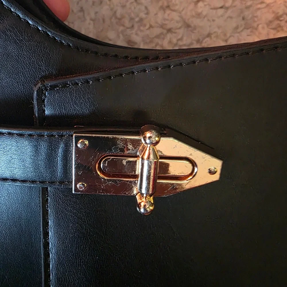 Minimalist black hobo shoulder bag gold hardware under arm‎